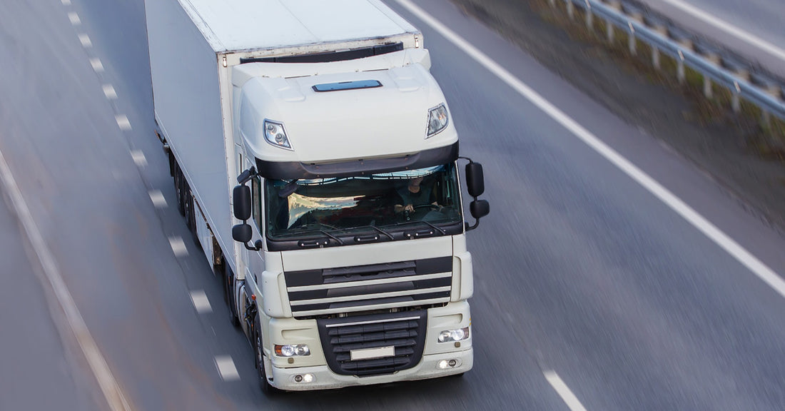 White HGV driving along mostly empty motorway
