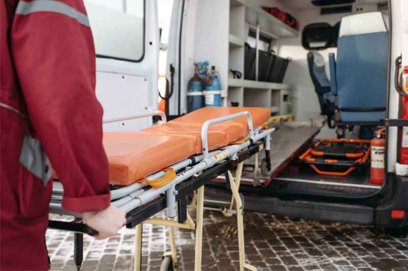 Paramedic at work is cautious not to slip on the icy and snowy ground